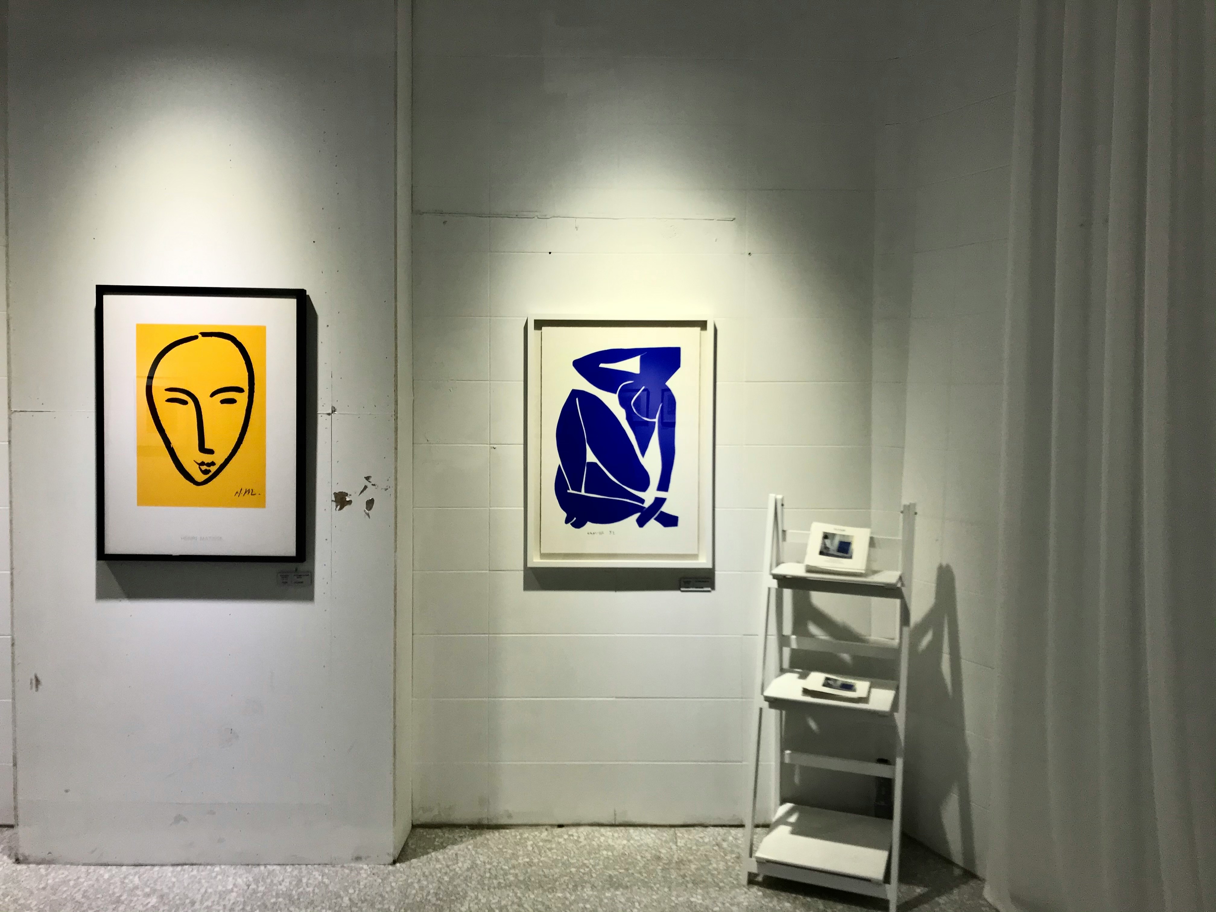 Museum gallery with framed works and polished floors